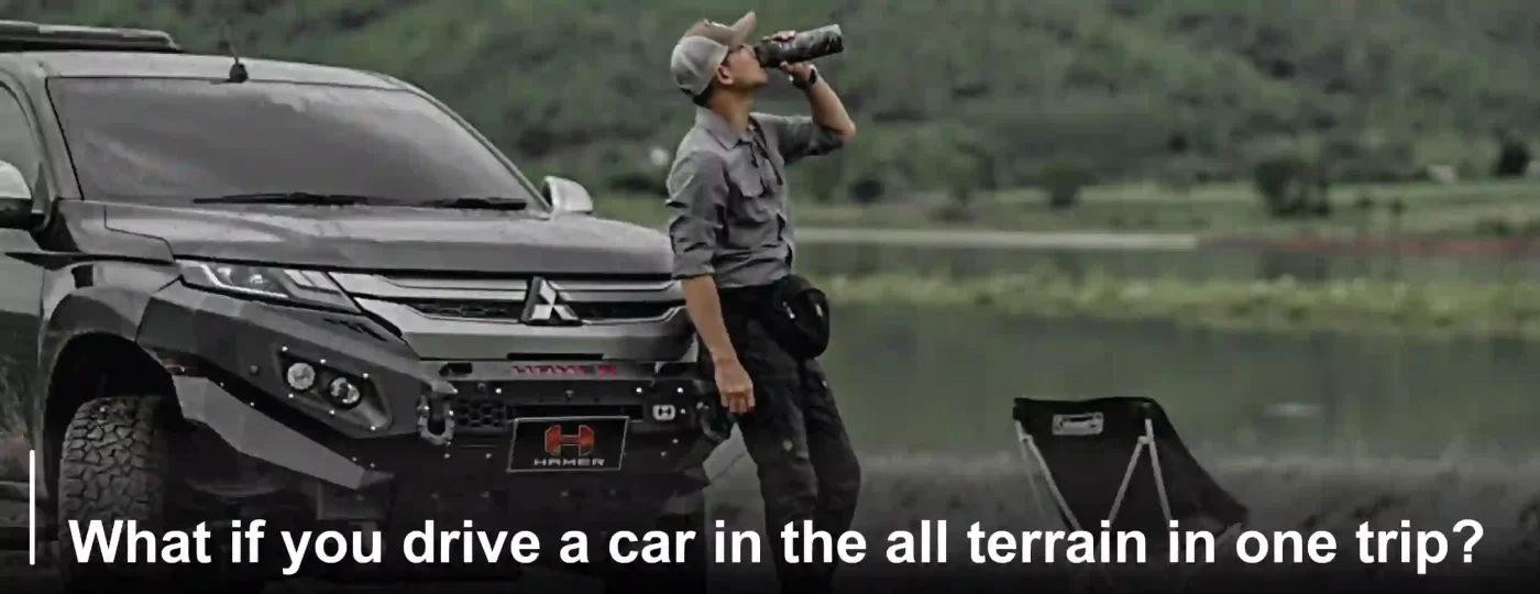 A man drinking water next to 4x4 black mitsubishi Hamer